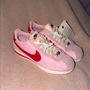Nike Women’s Pink Sneakers with Red Swoosh